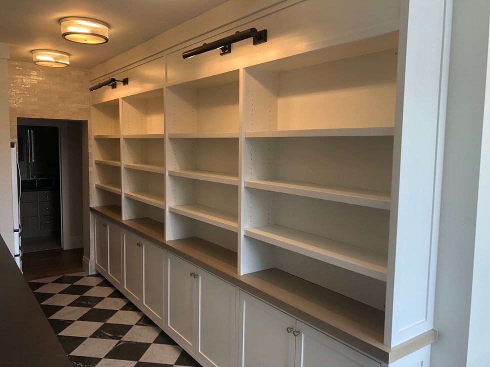 Floor-to-ceiling custom built-in shelving in a mudroom