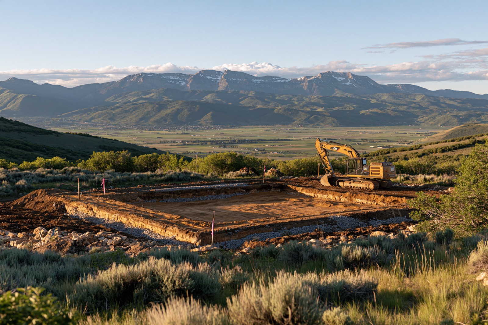 Excavation on a sloped mountain lot with a view over the valley