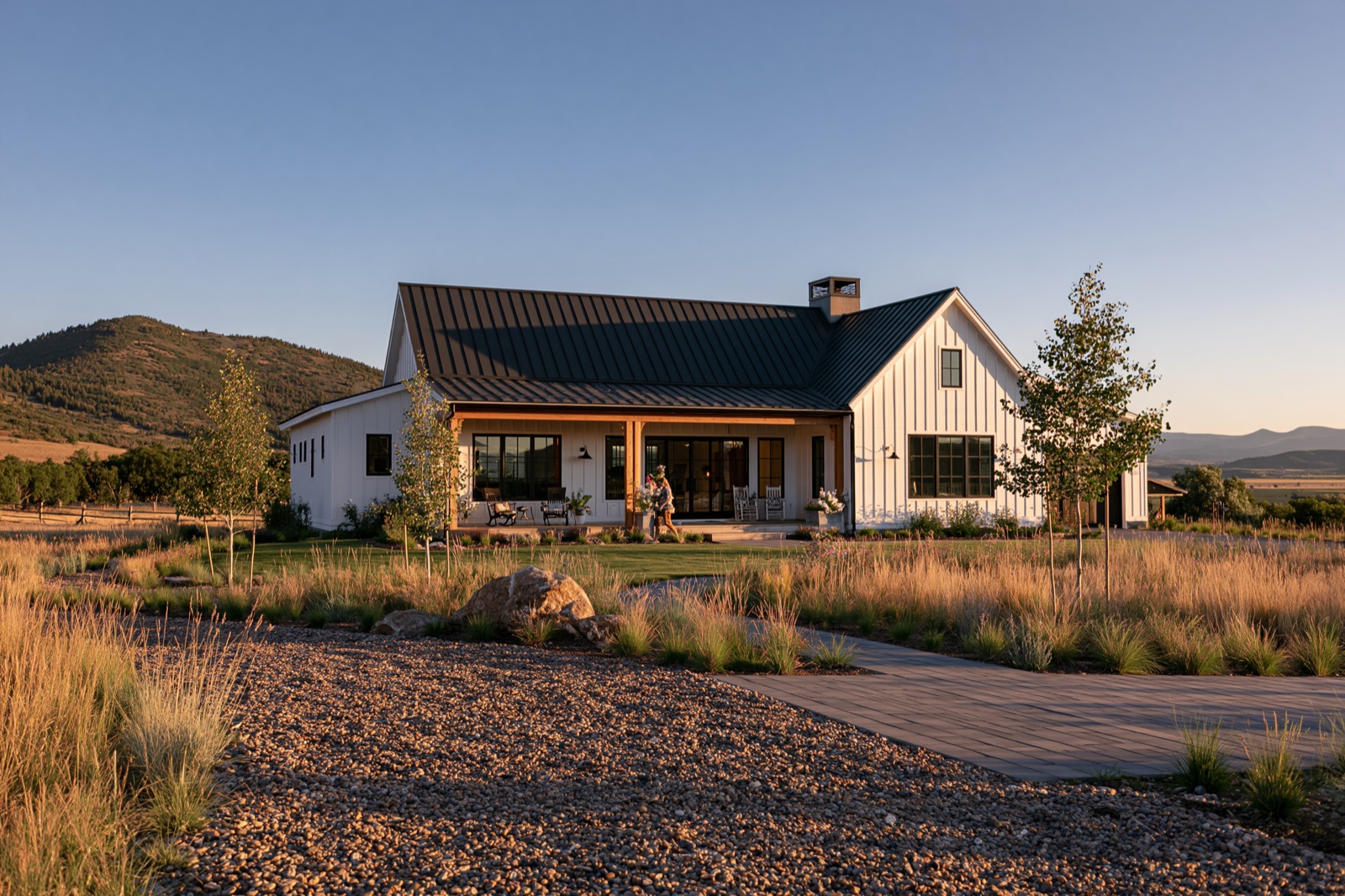 Modern farmhouse custom home with board-and-batten siding and a covered porch in summer
