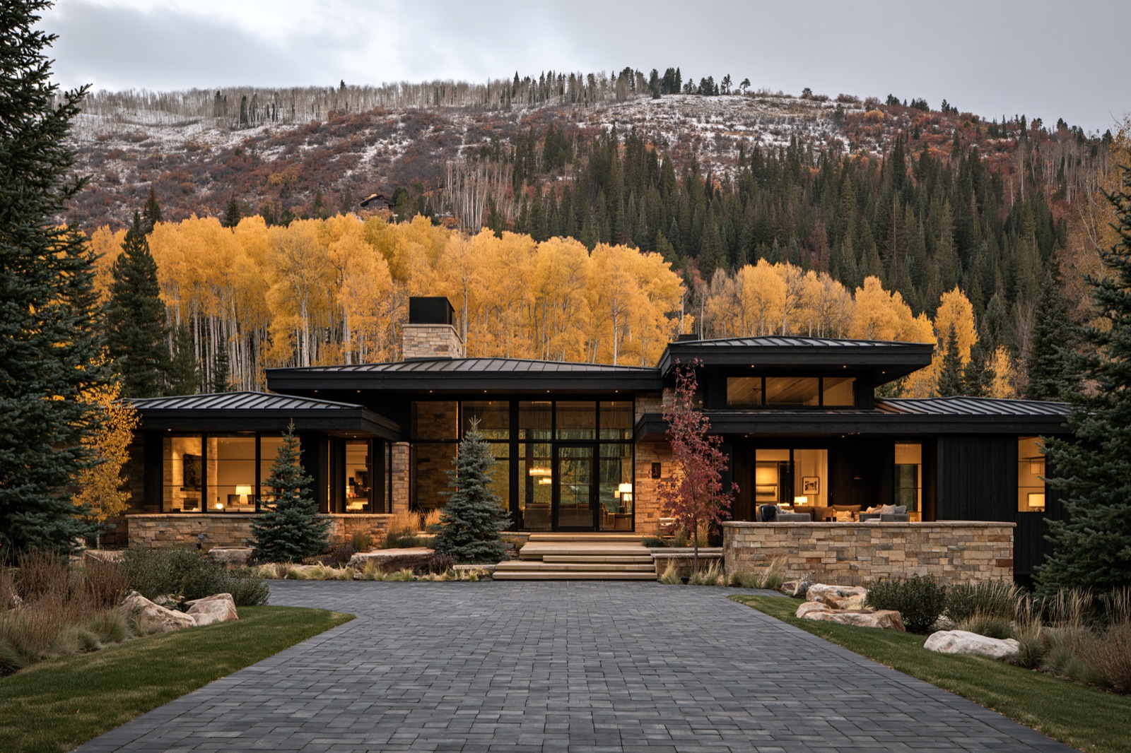Mountain contemporary custom home with stone and dark timber against fall aspens